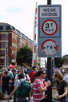 The warning sign fails to deter crowds from gathering on this bridge at the Bristol Harbour Festival 2009.