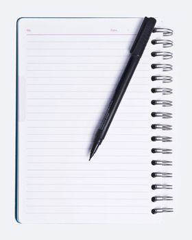 Isolated image of blank vertical spiral lined notebook and black pen