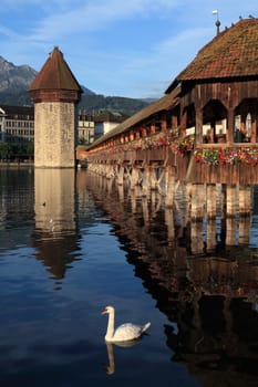 The Chapel Bridge and Lake Lucerne, in the city of Lucerne, Switzerland.  Photo taken early in the morning as the sun starts to rise.
