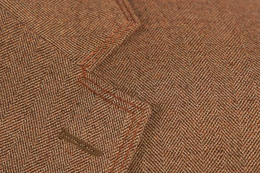 close-up of brown elegant buttonhole suit, textile classic