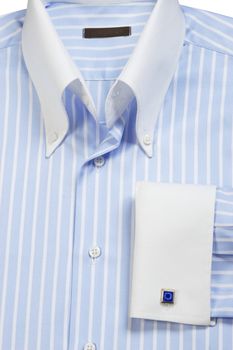 Close-up of cuff-link on blue striped shirt