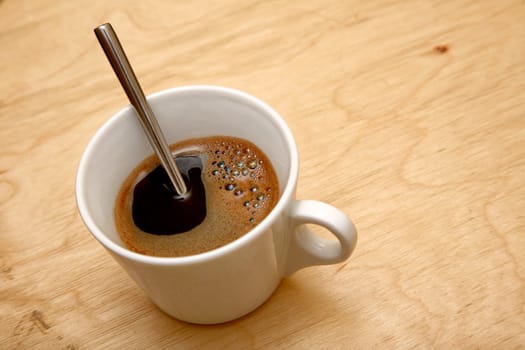 fresh cup of coffee on wooden background