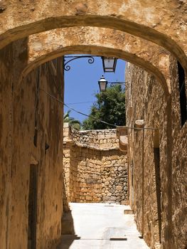 Old textured arches in one of the medieval streets in the citadel in Gozo