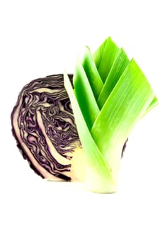 Red cabbage cut in half with a leek on a white background