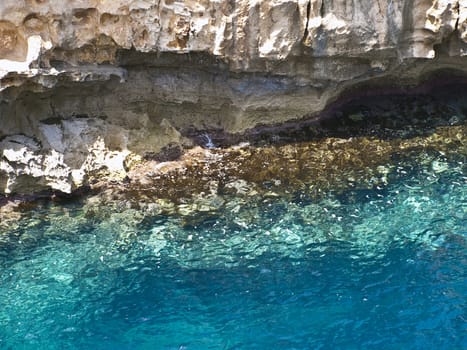 Detail of a rocky reef in Malta with beautiful crystal clear ocean water