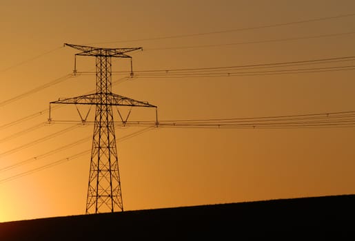 an electric pylon on sunset background