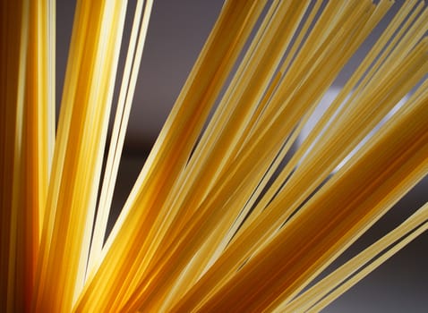 spaghetti pasta arranged as a fan on a blue background