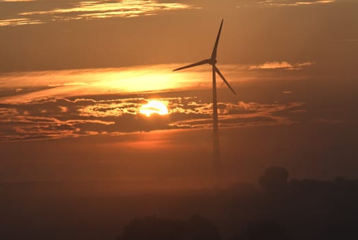 a windmill on sunset background