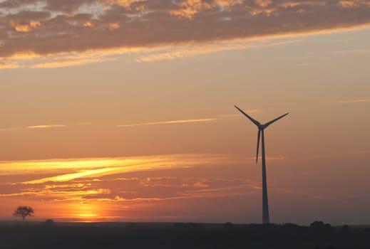 a windmill on sunset background