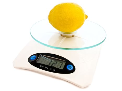 photo of the lemon at electronic scales against the white background