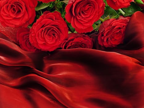 Red beautiful roses on a vinous silk fabric 