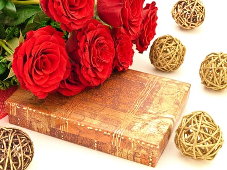 Red roses on a box with a gift 