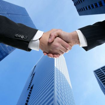 Businessman teamwork partners shaking hands with suit