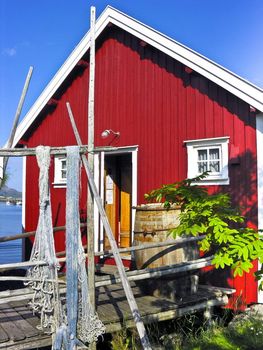 Red norwegian fisherman hut in Lofoten islands, Norway