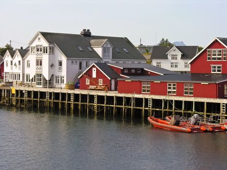 Norwegian style red house in lofoten island with boat