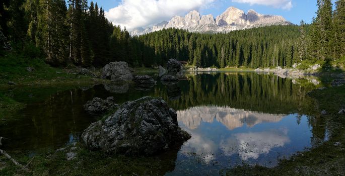 Reflection of the Dolomites in Italy in the quiet Carezza Lake