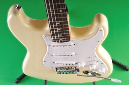 a basic electric guitar set against a green screen