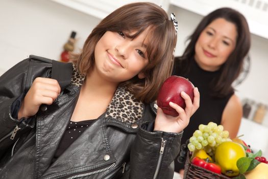 Pretty Hispanic Girl Ready for School with Mom in the Background.