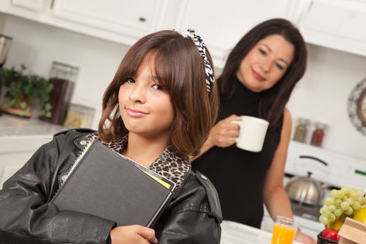 Pretty Hispanic Girl Ready for School with Mom in the Background.