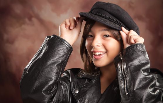 Pretty Hispanic Girl with Hat and Leather Jacket Studio Portrait.