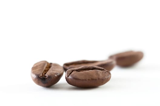 A close up shoot of some coffee beans isolated on white background