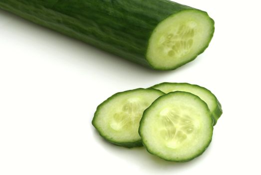 Part of a cucumber with some slices.