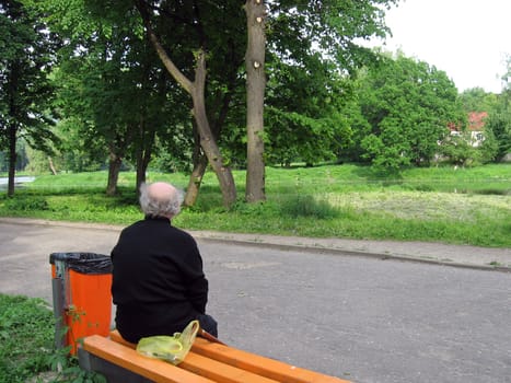 Old man in city taking a moment of rest