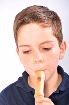 Studio Shot of a young boy playing recorder