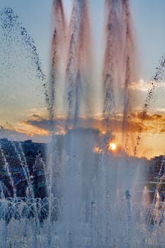 Top of a water fountain against a sunset  sky