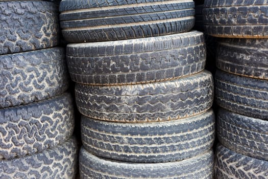 Pile of stacked old tires for rubber recycling.