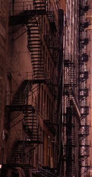 Chicago fire escape ladders in a dark alley