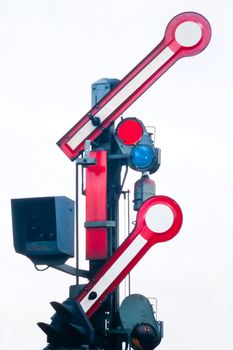 Old railway semaphore with propane signal light isolated on white.