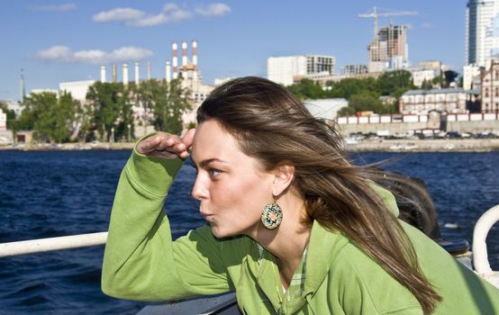 Beautiful girl on board the ship. Put his hand to his face and looking forward. Navigator. paving course.