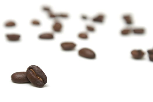 Two coffee beans infront of many others that have been blurred out.