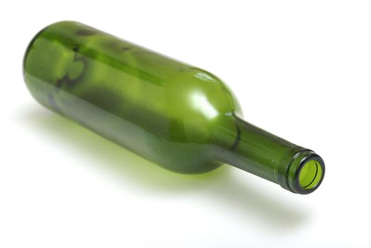 An empty wine bottle laying on it's side.