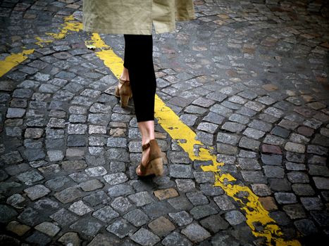 Young woman crossing the street.