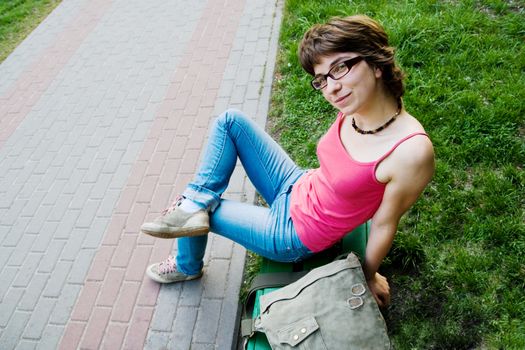 Pretty girl having rest on park bench