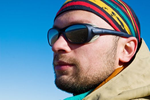 Hiker in sunglasses and colourful bandana