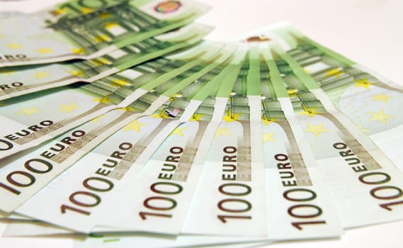 100 Euro notes on a white background.
