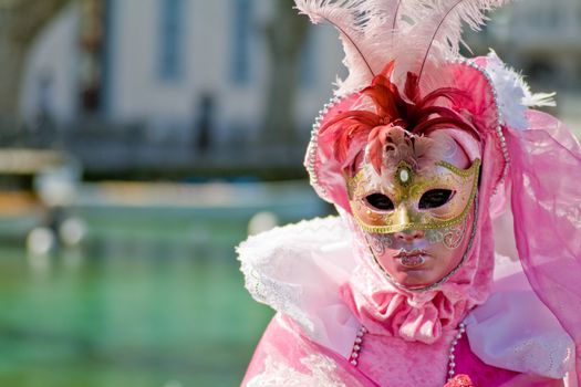 Carnival in venice with model dressed in various costumes and masks - pink lady