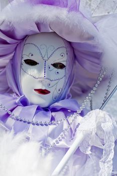 Carnival in venice with model dressed in various costumes and masks - violet lady
