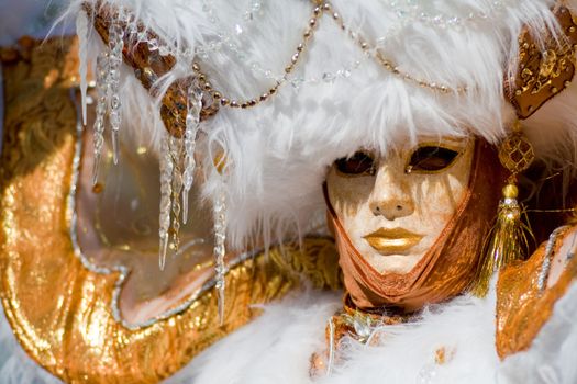 Carnival in venice with model dressed in various costumes and masks - gold lady