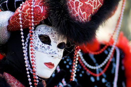 Carnival in venice with model dressed in various costumes and masks - black lady