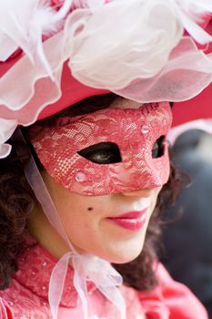 Carnival in venice with model dressed in various costumes and masks - pink lady