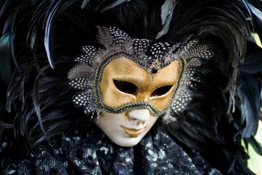 Carnival in venice with model dressed in various costumes and masks - black man