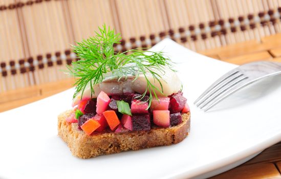 Sandwiches with rye bread, herring and vegetables