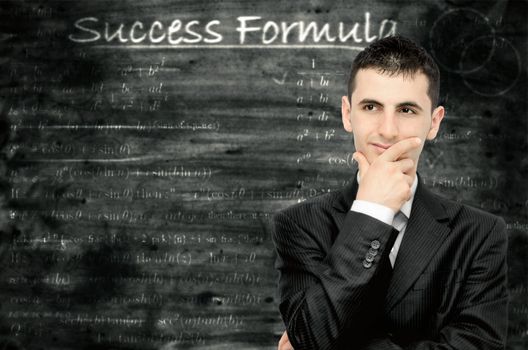A young businessman who is thinking about a formula for success