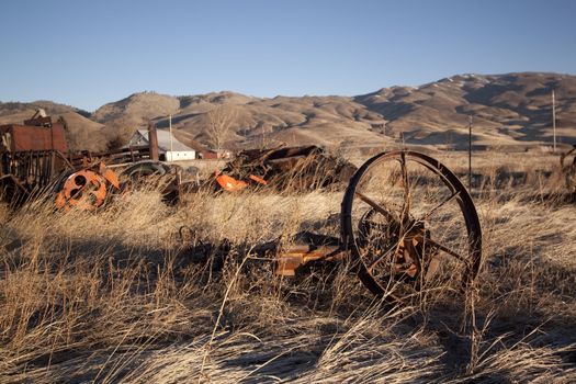 old rusty farm equipment in the middle of a field