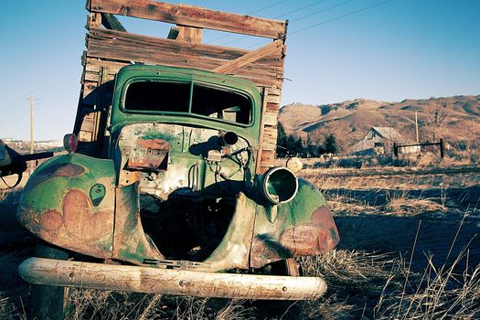 old rusty farm equipment in the middle of a field