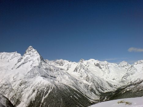 Mountain under the blue sky and the clouds